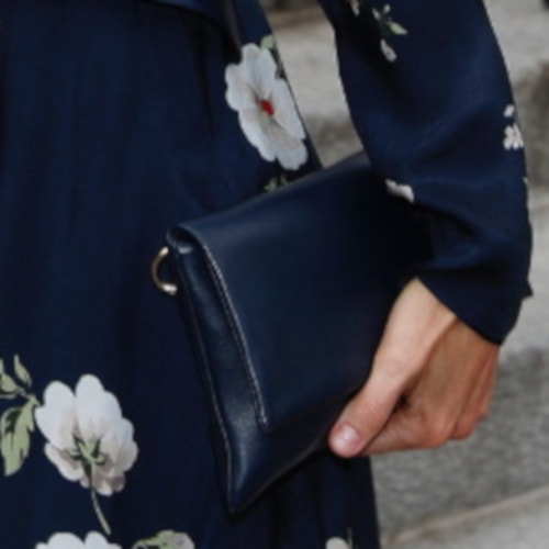 Queen Letizia carries Carolina Herrera 'Baret' navy leather clutch bag