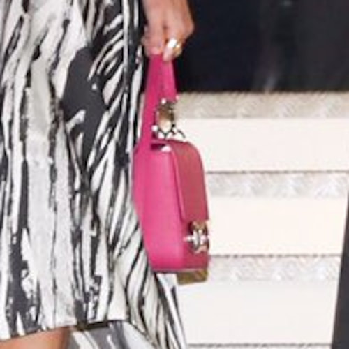 Queen Letizia carries fuchsia pink Carolina Herrera Initials Insignia small shoulder bag
