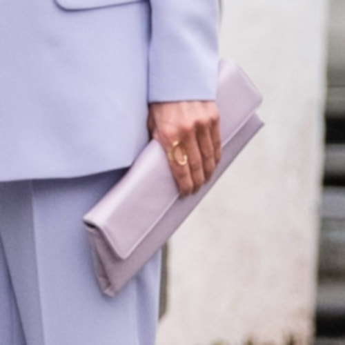 Queen Letizia carries lilac flap leather clutch