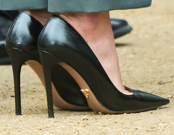 Queen Letizia wears black Prada Saffiano patent pointy-toe pumps