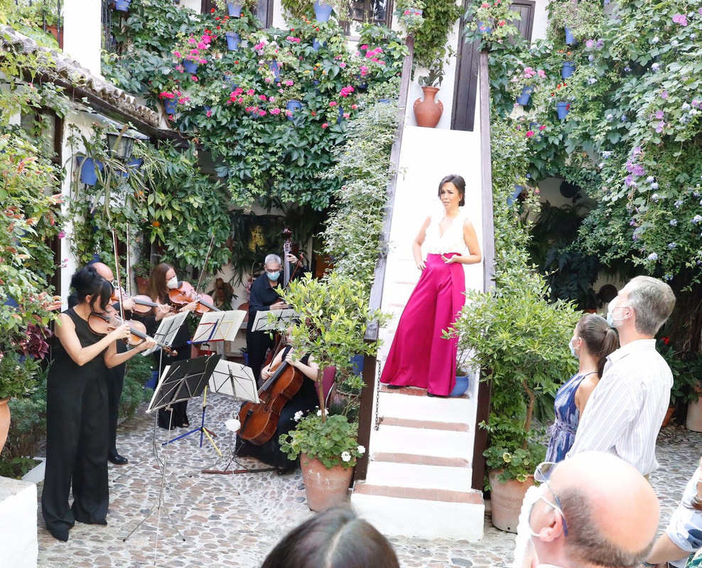 King Felipe VI and Queen Letizia watch a courtyard performance by Auxiliadora Toledano who was accompanied by several musicians from the Córdoba Municipal String Orchestra in Córdoba on 29 June 2020