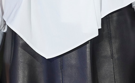 Closeup of Queen Letizia's black panelled leather A-line skirt 