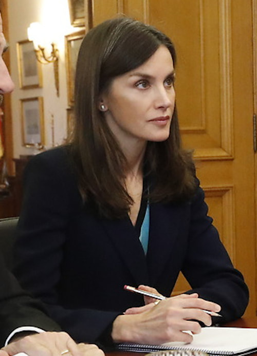 Queen Letizia wears navy blazer and a turquoise v-neck top with a contrast trim